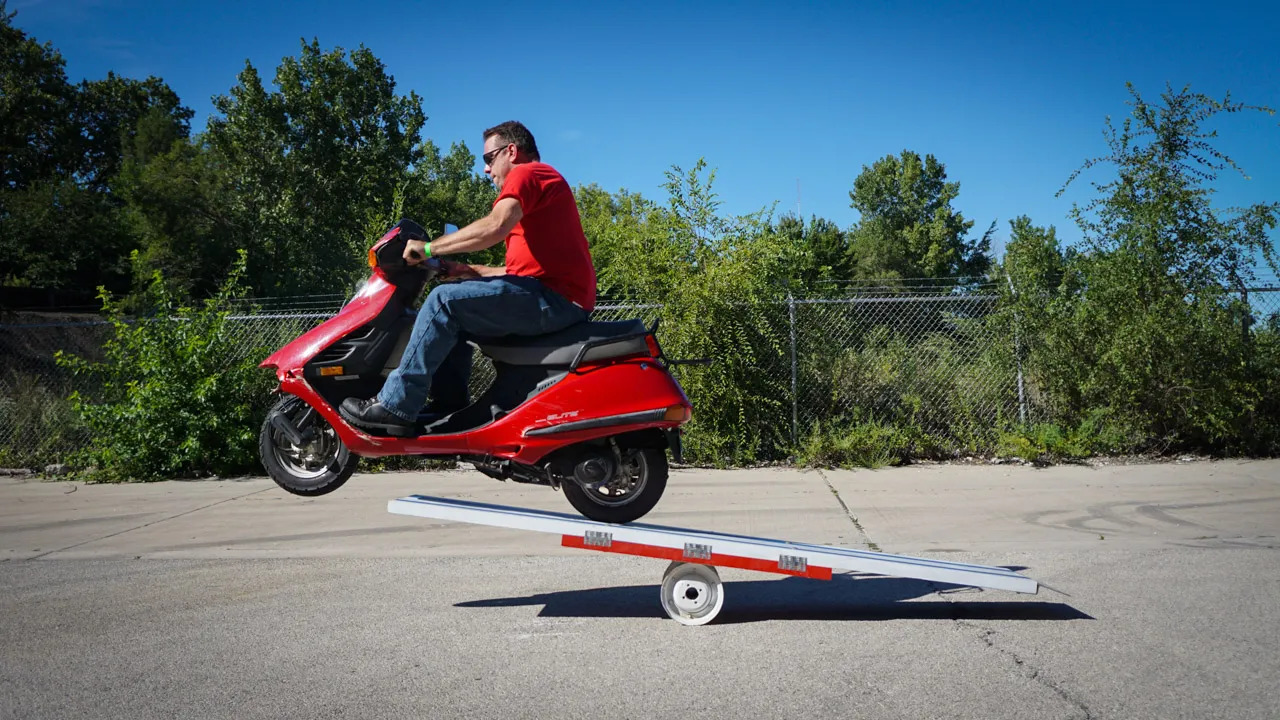 Scooter jumping a ramp